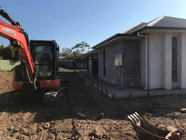 Excavate It Pty Ltd in Toongabbie, levelling side of house and driveway for concrete